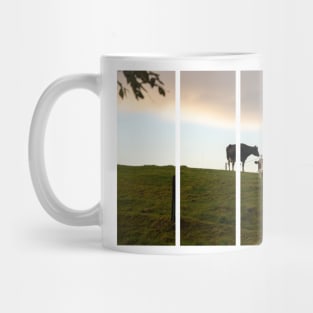 Two cows on the hill at sunset after a shower. Backlight. Mug